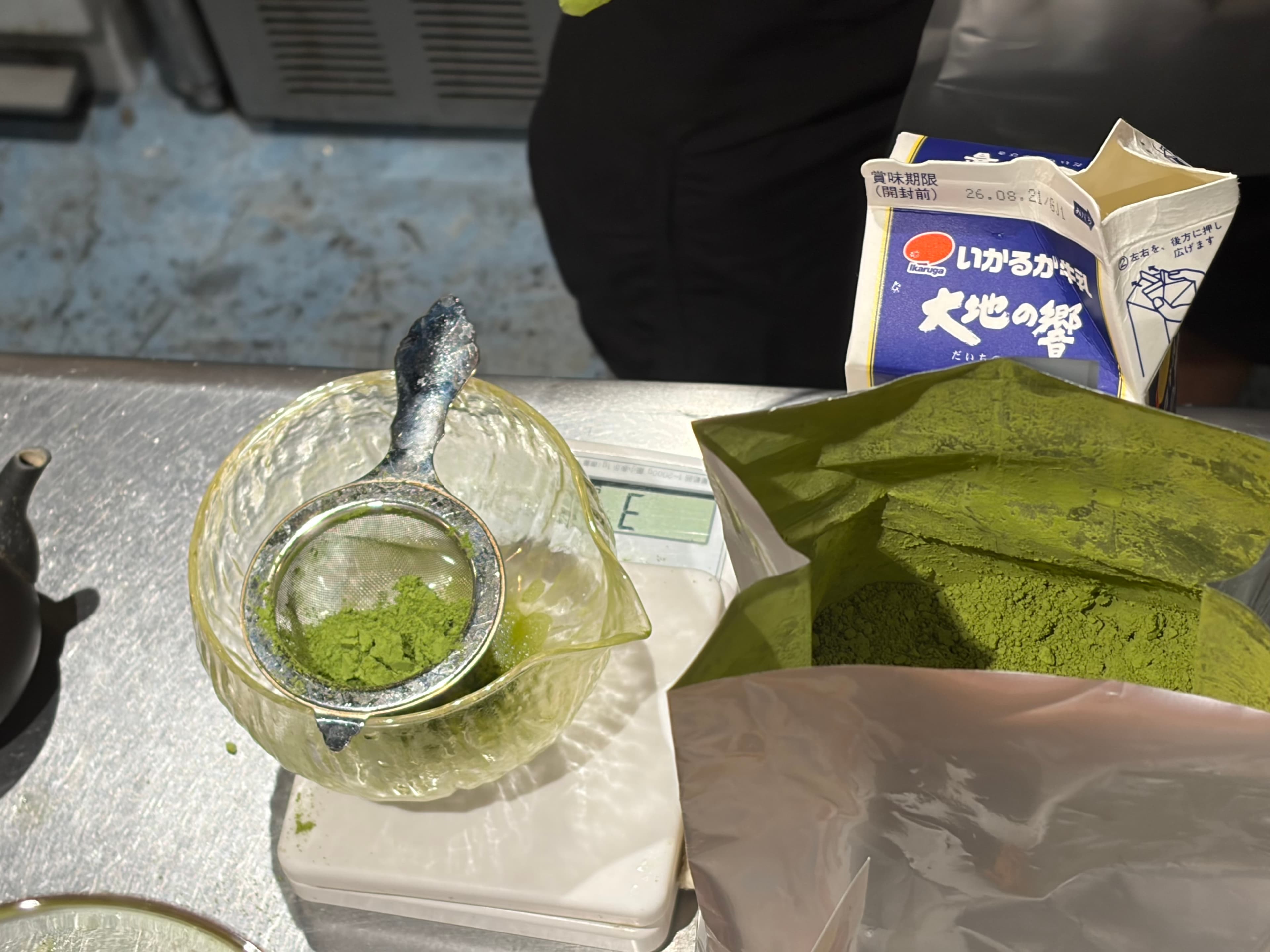 Matcha powder sifted into a glass teapot